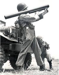 Trooper stands with Redeye missile laucnher, back against the vehicle 1960.jpg