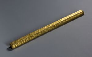 Long wooden rod covered in gold leaf and hieroglyphic inscriptions