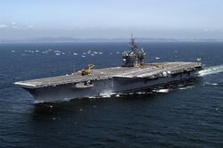 US Navy 050517-N-0120R-127 The conventionally powered aircraft carrier USS Kitty Hawk (CV 63) sails past a small group of Japanese fishing vessels and heads toward Sagami Bay.jpg