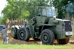 U.S. Army Sgt. 1st Class Tim Catoe with the 1782nd Engineer Company, South Carolina Army National Guard, guides the operator of a scoop loader clearing the route for a convoy of construction vehicles, during 130518-Z-WT236-005.jpg