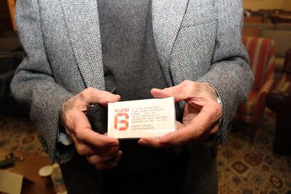 Robert Anders with his fake Studio 6 business card.jpg