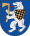 A coat of arms depicting an angry, grey bear with yellow claws and a long, red tongue gripping a yellow axe in its paws all on a blue background
