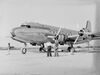 Three men standing before a 'Pacific Overseas Airlines' plane (AM 86577-1).jpg