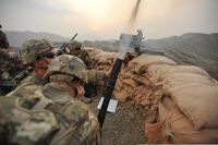U.S. Army Spc. William Marsh, a mortarman, covers his ears as Sgt. John Keller, a mortarman, fires a high-explosive mortar shell from an M224 60 mm mortar system while Spc. Jacob Connolly, a fire support 130927-Z-RK751-260.jpg