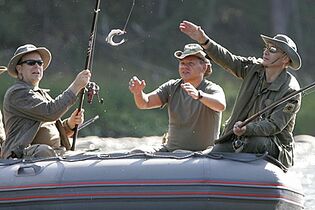 Путин (справа) рыбачит на реке Енисей во время сплава вместе с князем Монако Альбером II (слева) и Шойгу. Тыва, 13 августа 2007 года