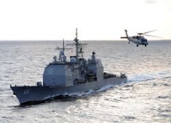 US Navy 100119-N-4236E-168 The guided-missile cruiser USS Hue City (CG 66) prepares for a replenishment at sea while an MH-60S Sea Hawk helicopter.jpg