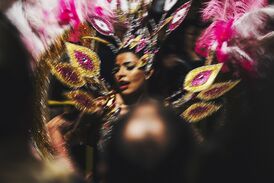 Carnival of Madeira dancer in her shiny peacock dress.jpg