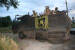 Soldiers in truck reinforced with steel plates.jpg