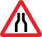 Road narrows on both sides