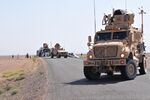 U.S. Soldiers use a MaxxPro Dash mine-resistant, ambush-protected vehicle and a mine-resistant, ambush-protected all-terrain vehicle to cordon off a road in southwestern Afghanistan July 6, 2011 110706-A-UB106-182.jpg